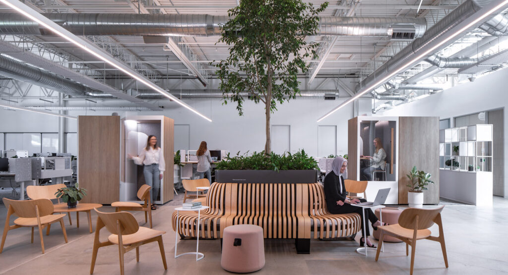 Modern office space with employees at work and casual seating areas.