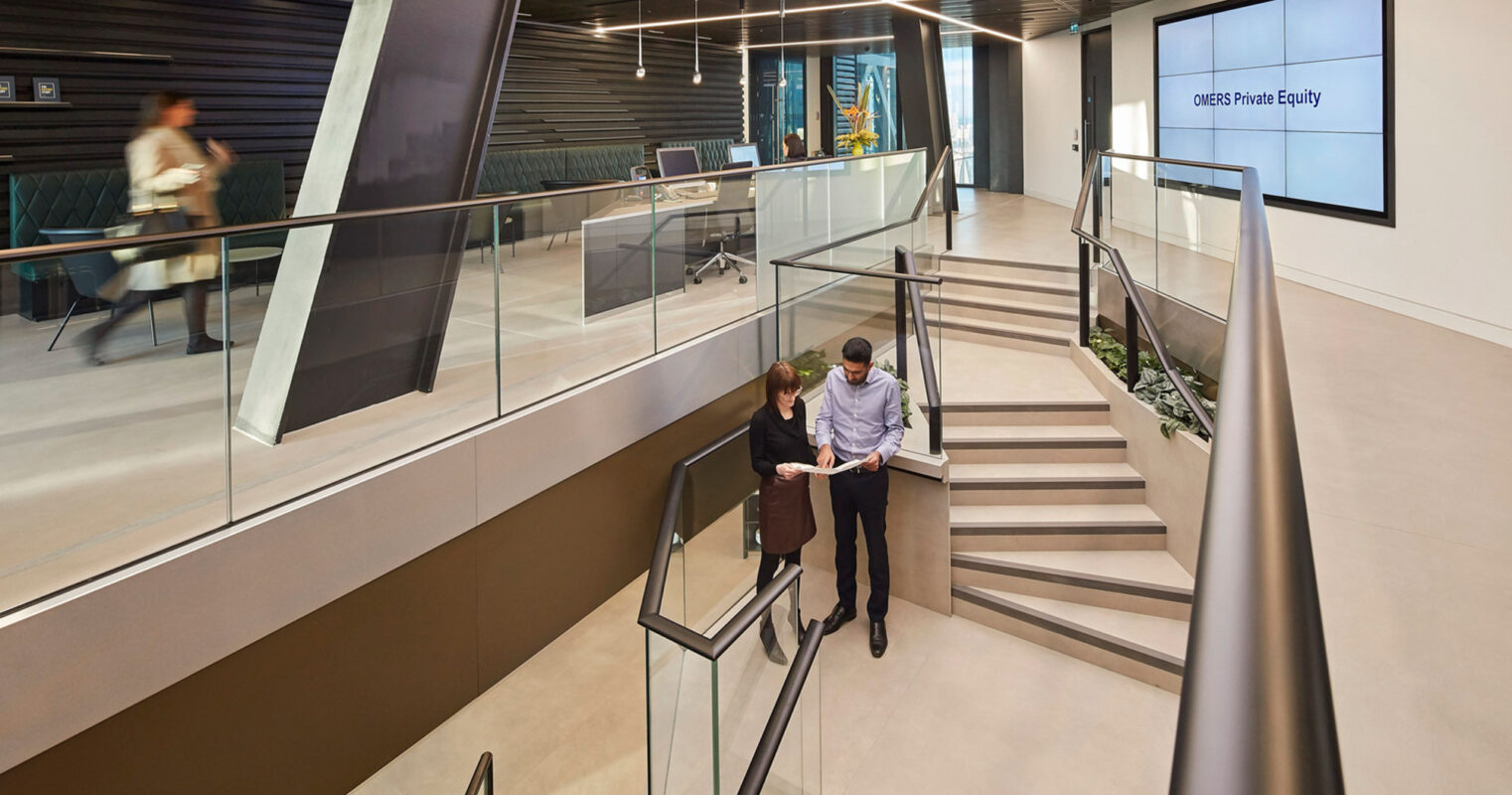 Modern office interior showcasing a sleek staircase with metal railings connecting split levels. Glass partitions create transparent office spaces, while a digital screen displays 'CDRS Private Equity.' Ambient lighting emphasizes the geometric lines and professional ambiance.