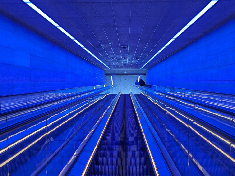 Escalator with royal blue interiors throughout.