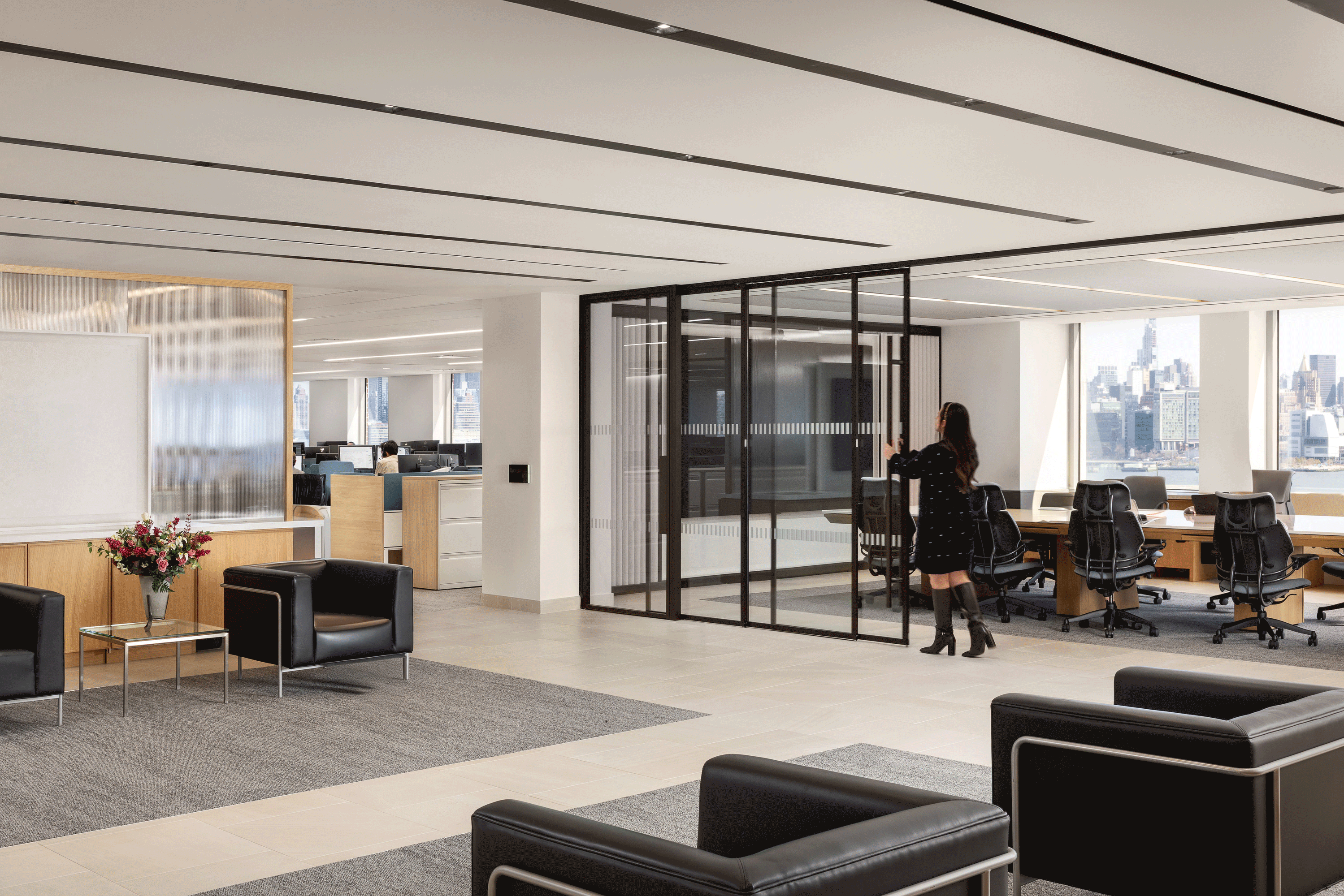 Gif showing a contemporary office interior with a moveable wall that allows a conference room to flex open to the office space beyond.